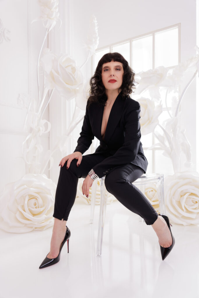 Berlin Dominatrix Lady Vyra in a black suit and black high heels 