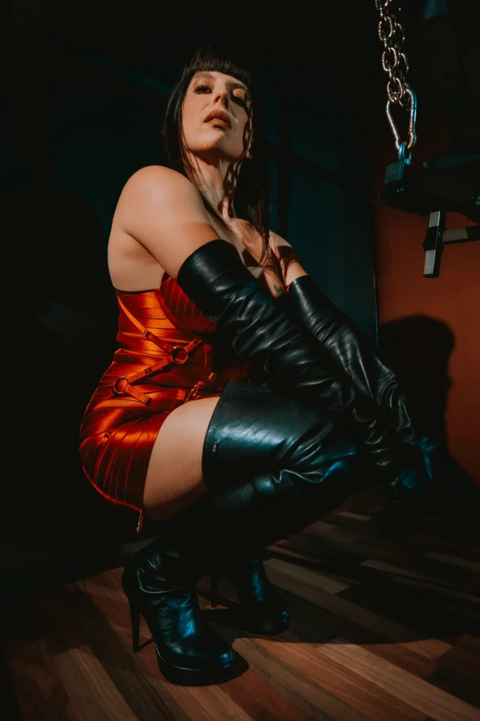 Lady Vyra showing off her leather thigh-high boots and lingerie